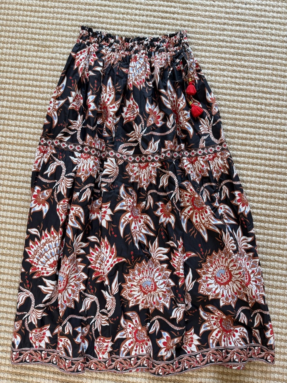 NWOT Omika Black Floral Tiered Maxi Skirt with Red Tassels